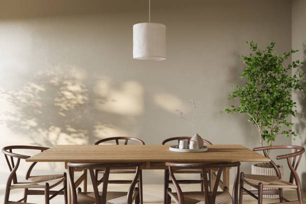 istock Modern minimalist empty dining space with a wooden table, matching chairs, and soft natural shadows 2190444936