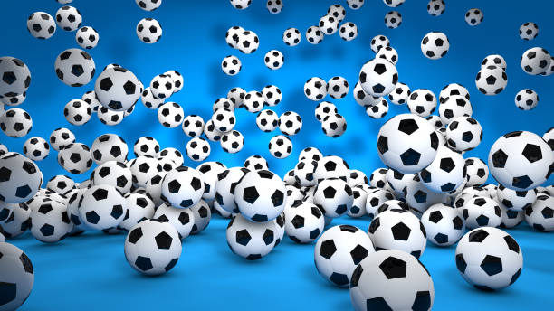 Hundreds of soccer balls bouncing from the air to the ground in a studio with a blue floor create a fun atmosphere. / You can see the animation movie of this image from my iStock video portfolio. Video number: 2190283179