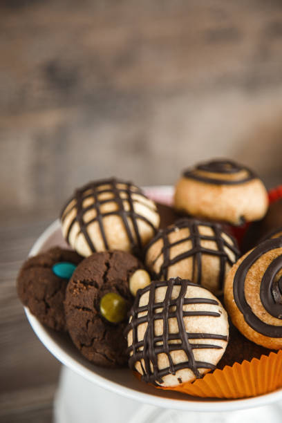 Stock photo showing close-up, elevated view of an assortment pile of luxury collection of Belgian chocolate biscuits.
