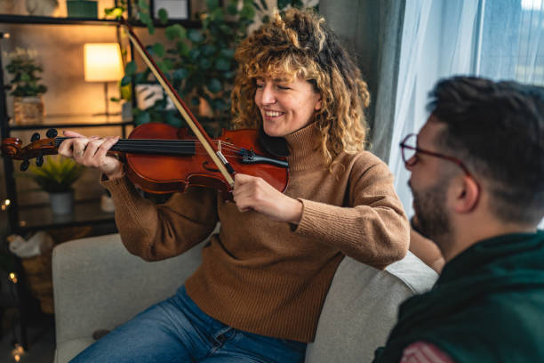istock boyfriend teach girlfriend how to play violin practice at home 2190446741