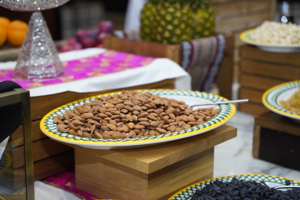Vibrant platter of roasted almonds displayed elegantly on a colorful plate, surrounded by tropical fruits, inviting guests to enjoy a healthy and flavorful snack.