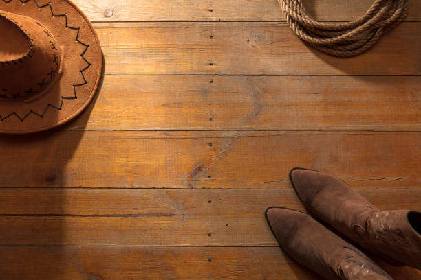 Cowboy boots and  Mexican spurs in black and white sepia tone with room for your type.