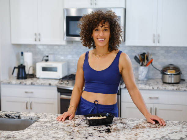 istock Woman Warming a Ready-to-Eat Meal in a Home Kitchen 2190447876
