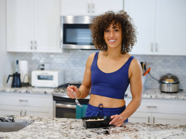 istock Woman Warming a Ready-to-Eat Meal in a Home Kitchen 2190447885