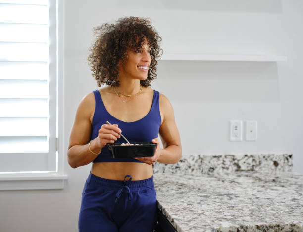 istock Woman Warming a Ready-to-Eat Meal in a Home Kitchen 2190447897