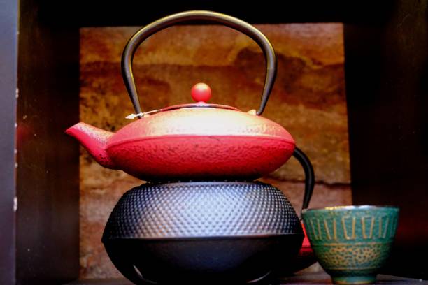 istock Cast iron colored teapot - teapots and cast iron cups next to them. 2190448026