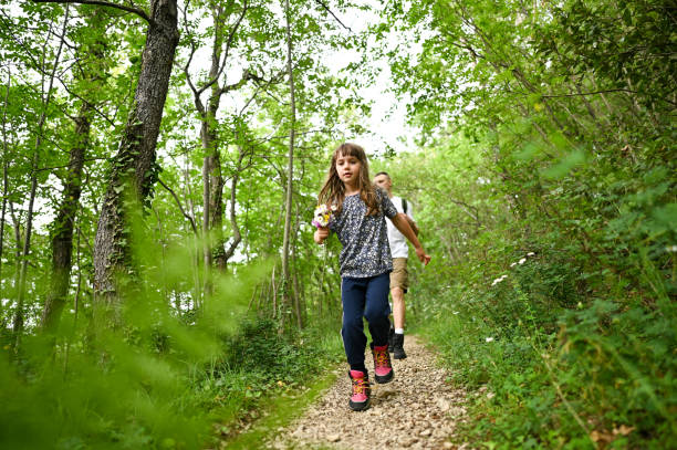Young family hiking in forest.