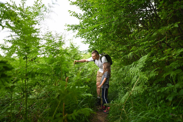 istock Family in green glade exploring nature. 2190449399
