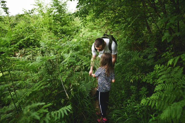 istock father with daughter hiking in wilderness area. 2190449841