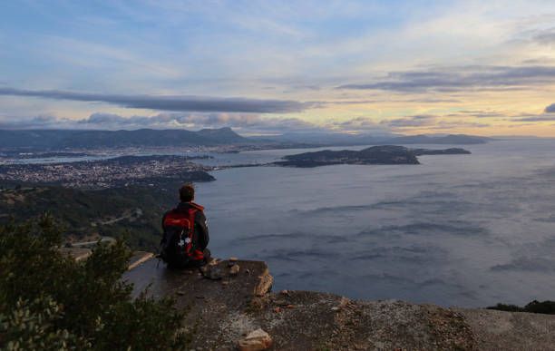 istock Young woman looks across bay from viewpoint 2190453455