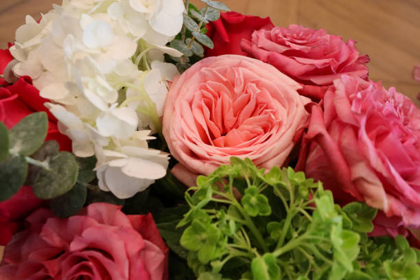 istock A vibrant bouquet featuring soft pink garden roses, white hydrangeas, lush greenery, and eucalyptus, arranged for a fresh, elegant floral centerpiece or gift. 2190453482