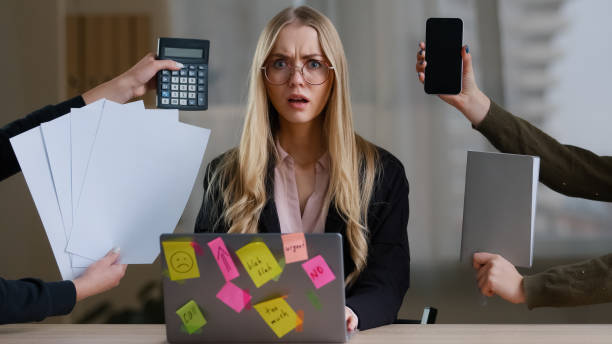 istock Multitasking business woman manager in office sitting at table have many tasks work feeling stress overworked exhausted from hands with calculator notebook papers phone tired girl in glasses headache 2190457269