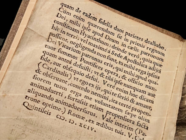 istock Simple old antique generic medieval book written in Latin gothic font, black ink letters object closeup detail, nobody, middle ages religious books and literature, cultural heritage concept, no people 2190459838