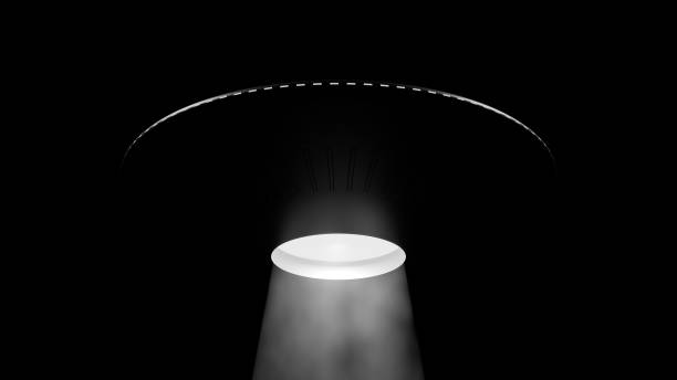 istock Illustration of a UFO hovering in the night sky 2190460744
