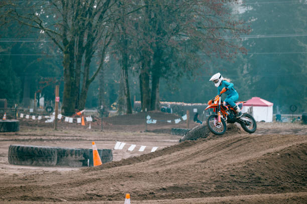 Motorbike, jump and man in the air with blue sky, mock up and stunt in sports with fearless person in danger with freedom. Motorcycle, jumping and athlete training for challenge or competition