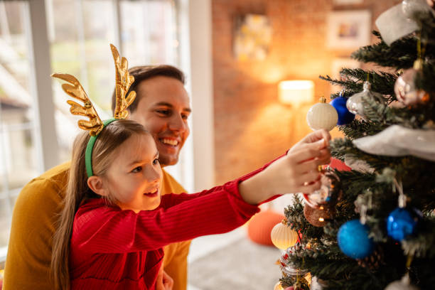istock Father playing with daughter during joyful Christmas celebrations at home 2190463666