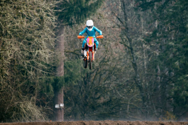 Bike, motorcycle and jump on blue sky mockup for speed challenge, sports and fearless risk. Driver, air stunt and driving with adrenaline in competition performance, adventure and fast motorbike race