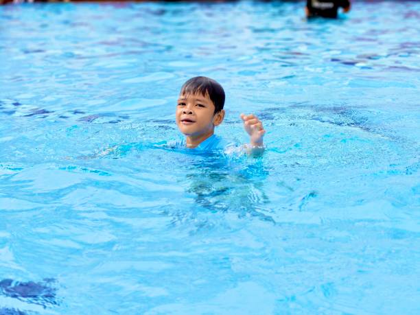 istock Asian school boy swimming at pool 2190471357