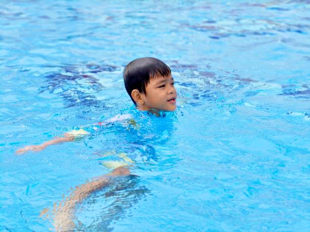 istock Asian school boy swimming at pool 2190471367