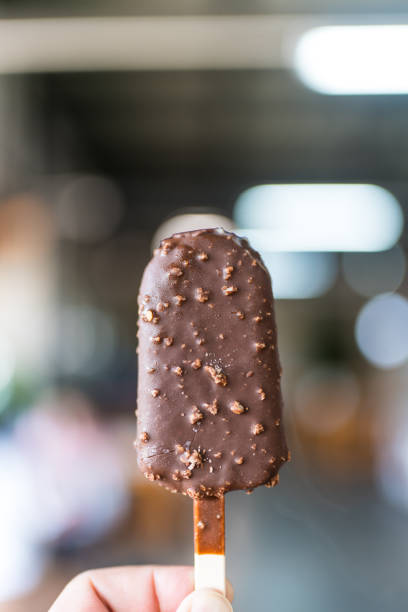 istock Chocolate popsicle ice cream bar with crushed peanut nuts. 2190472812