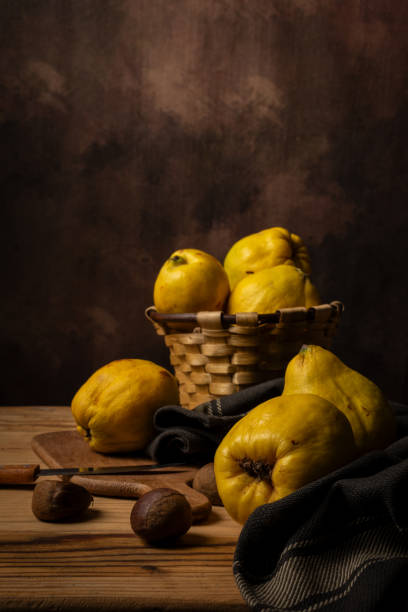 istock View of basket with quinces and nuts on table, dark background 2190474766