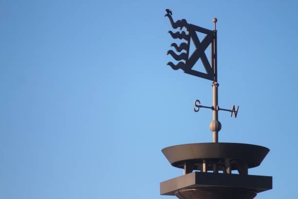 istock A weather vane is on top of a building 2190475018