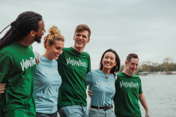 istock Happy volunteers walking together near river 2190476160