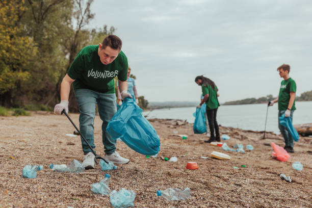 istock Volunteers cleaning plastic waste from riverbank: protecting the environment 2190476173