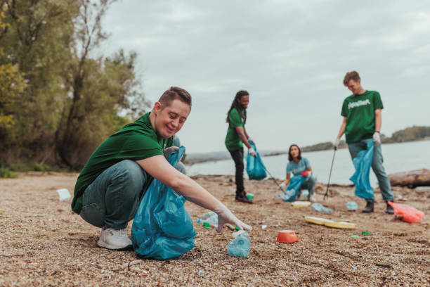 istock Volunteers cleaning plastic waste on river bank 2190476178