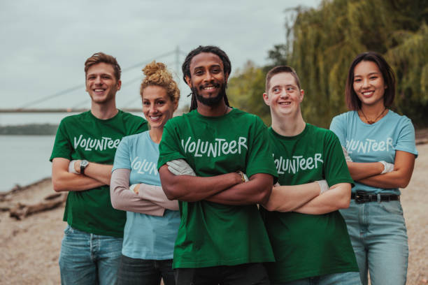 istock Volunteers smiling with arms crossed by the river 2190476189