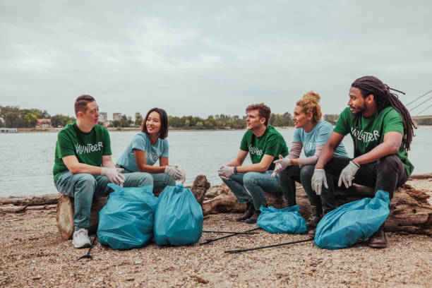 istock Volunteers collecting garbage near river 2190476195