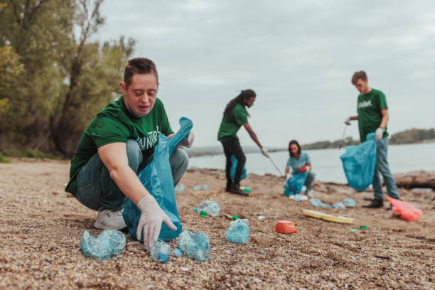 istock Volunteers collecting plastic waste on river bank 2190476196