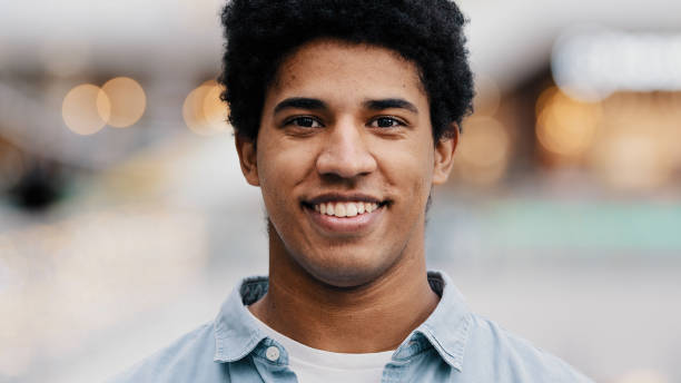 istock Front view portrait male face close-up african millennial man guy looking at camera smiling waving nods head answering yes positive decision agreement support approval good idea agree indoors portrait 2190476695