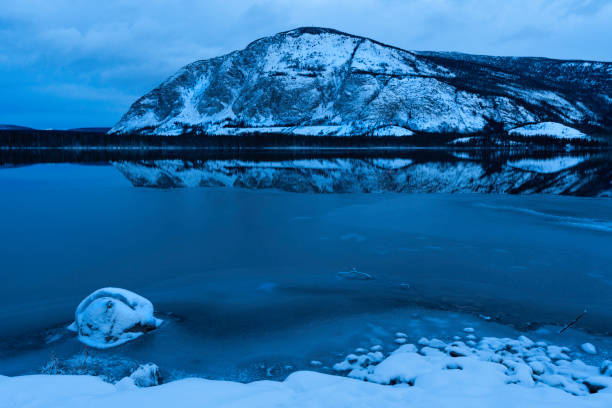 Reflections of mountains on Pine Lake in Kluane National Park at dawn, Haines Junction,  Yukon, Canada