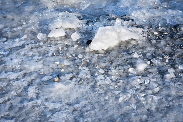Closeup of rocks and ice forming on shore of a Kluane Lake in Kluane National Park in winter, Haines Junction,  Yukon, Canada