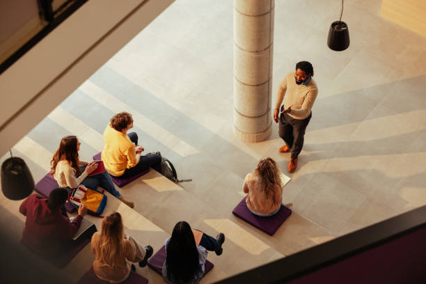 istock University teacher explaining lesson to diverse group of students 2190479029