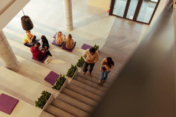 istock University students walking down stairs in modern building 2190479033