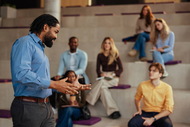istock Professor giving a lecture to diverse group of students in modern university auditorium 2190479045