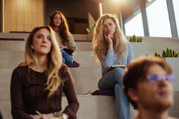 istock Students listening attentively during university lecture in modern auditorium 2190479134