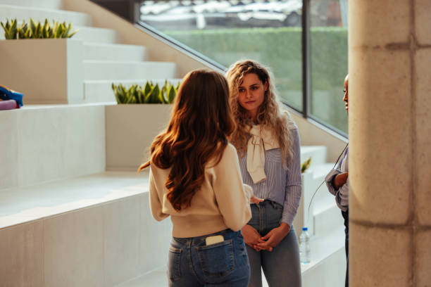 istock Young businesswomen discussing during a break in modern office 2190479847