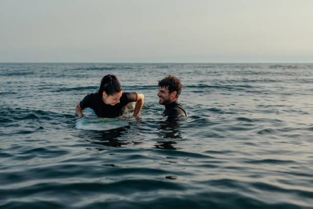 istock Two surfers in the water 2190480333