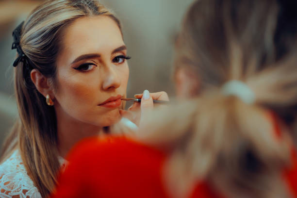 istock Professional Makeup Artist Using Brush to Apply Lipstick 2190481780