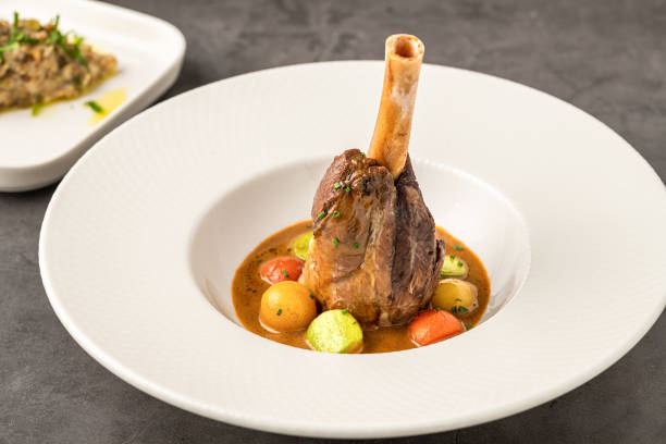 istock Traditional slow-cooked braised lamb knuckle or lamb shank with sauces 2190487521