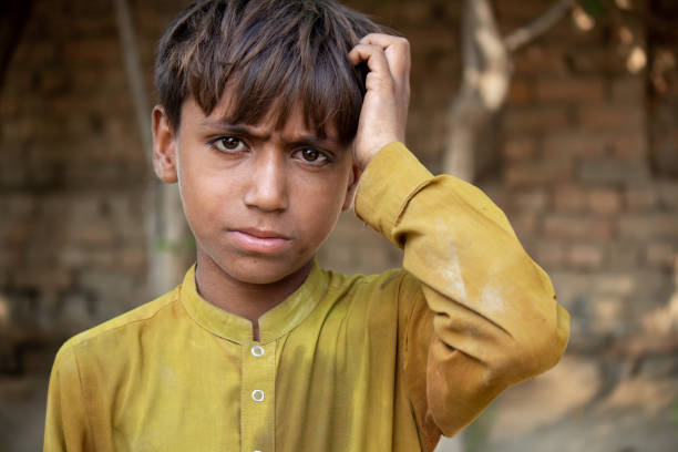 istock a Young Boy in Yellow Traditional Clothing Touching His Head 2190488258