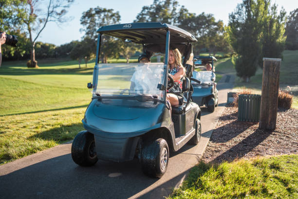 istock Mature Asian and Caucasian Women Joyfully Driving on Golf Course 2190489046