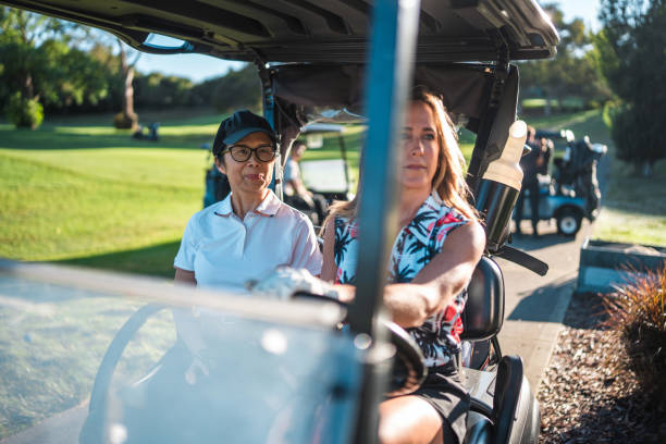 istock Mature Asian and Caucasian Women Enjoy Driving on Golf Course 2190489049