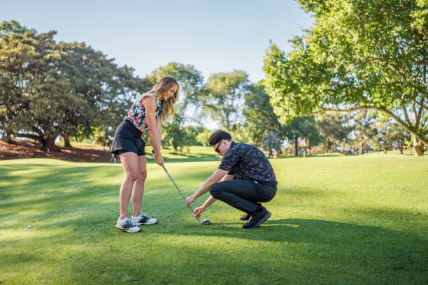 istock Caucasian Woman Learning Golf with Diverse Instructor Outdoors 2190489074