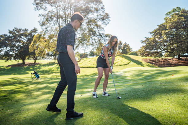 istock Caucasian Female Enthusiastically Learning Golf with Diverse Instructor 2190489076