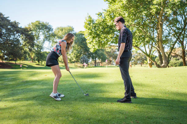 istock Caucasian Female Enjoys Golf Session with Diverse Instructor 2190489077