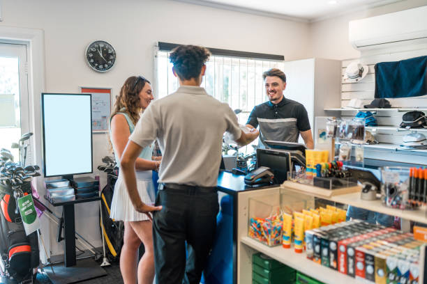 Enthusiastic Caucasian Male Golf Store Attendant Greeting Customers